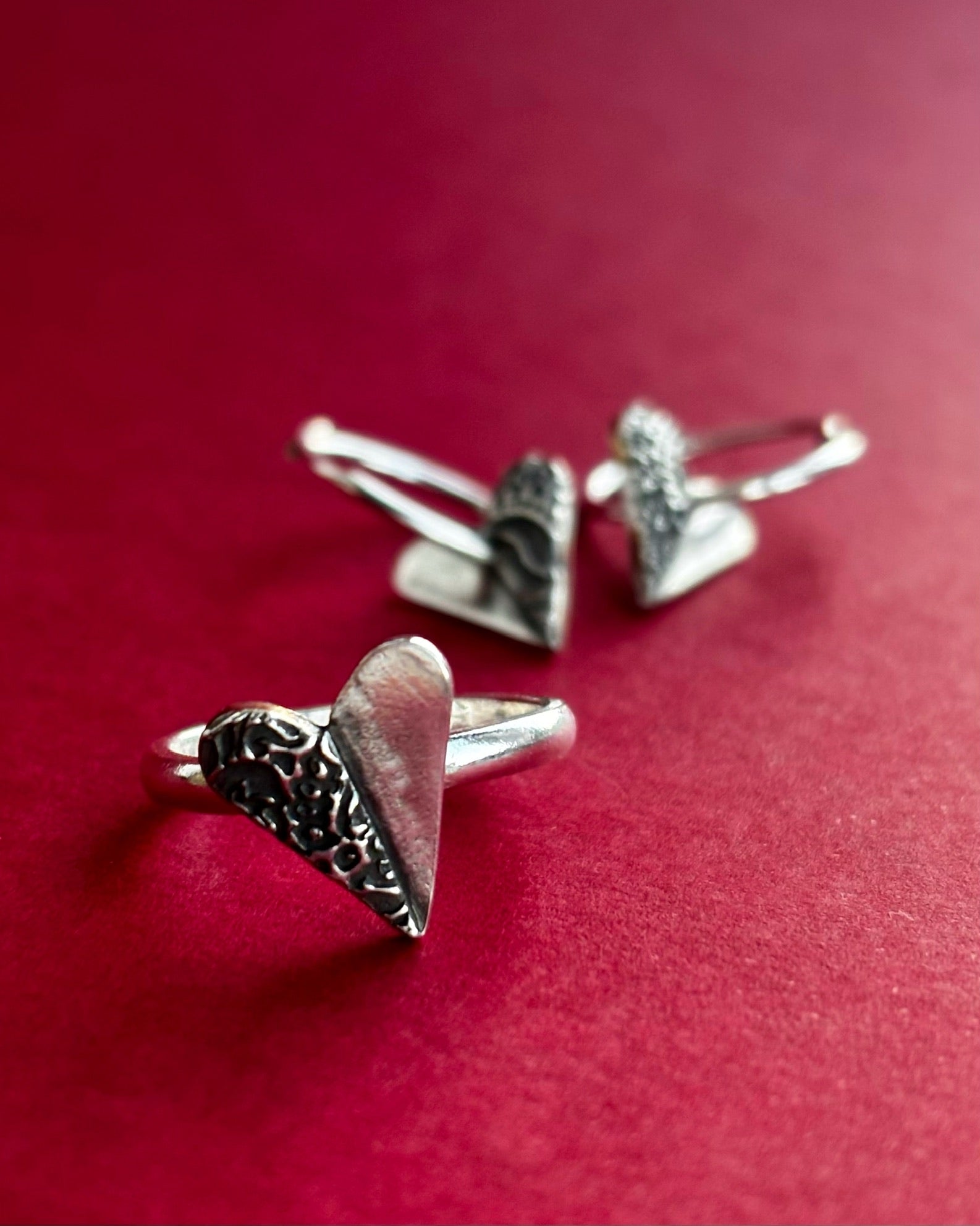 Handcrafted silver ring with delicate heart-shaped embellishment, designed with a minimalist shine and perfect for everyday wear or special occasions, sustainable jewellery made with recycled silver.