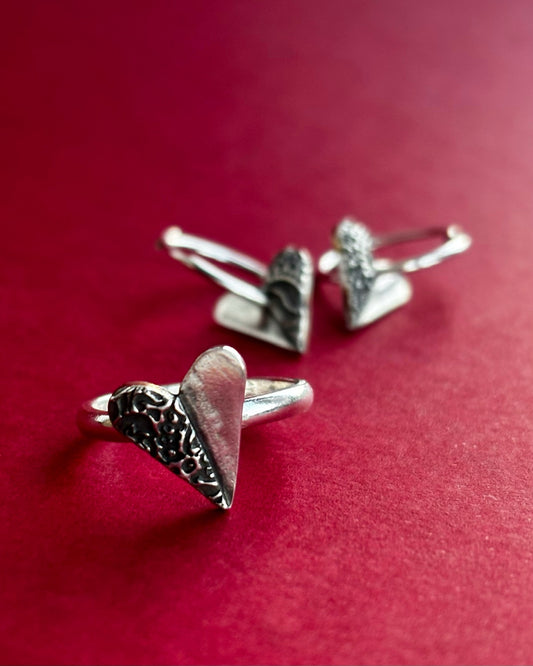 Handcrafted silver ring with delicate heart-shaped embellishment, designed with a minimalist shine and perfect for everyday wear or special occasions, sustainable jewellery made with recycled silver.