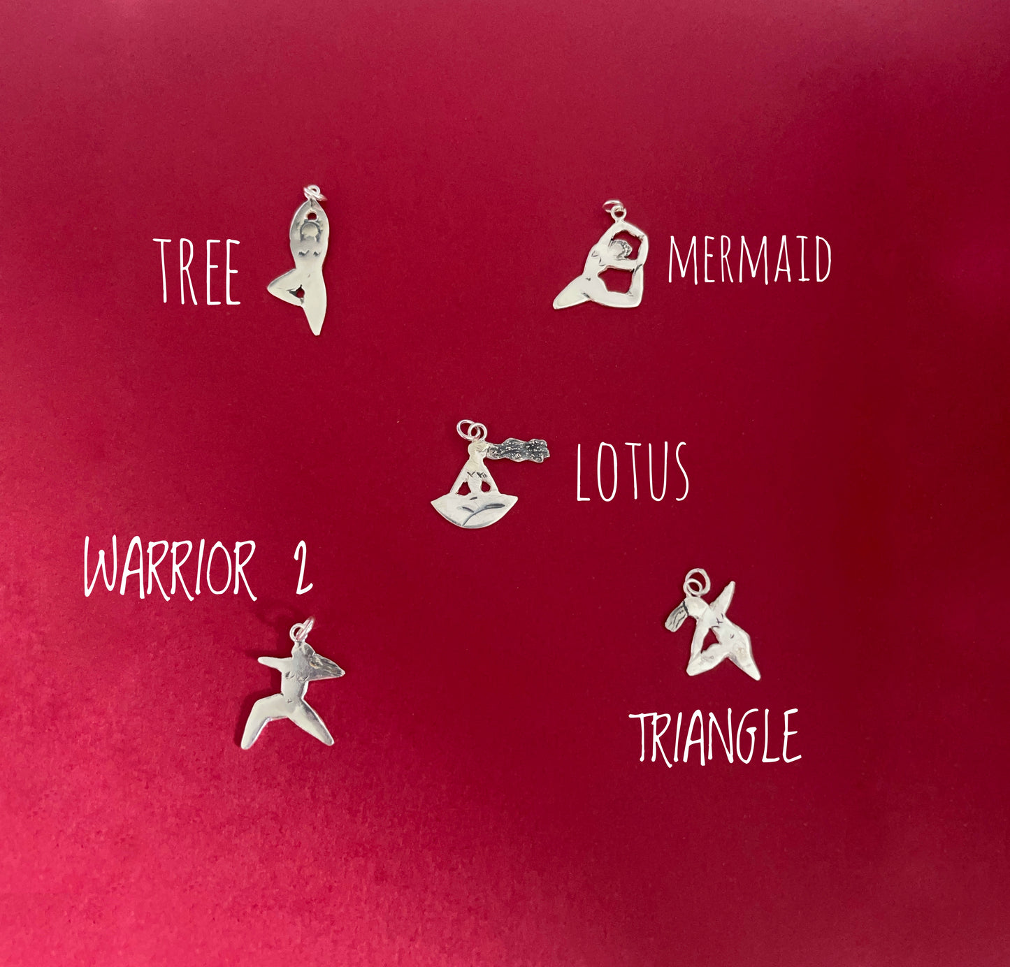 Five handmade sterling silver yoga pose pendants, showing the full collection together. Each pendant is hand-cut from sterling silver sheet in a loose doodle-style design, featuring a different yoga pose with simple, flowing lines. The scale of the pendants is shown against the hand, highlighting their lightweight, delicate feel and handmade character. Sustainable handmade Irish jewellery by an Irish jewellery designer, inspired by yoga, movement and mindful living.